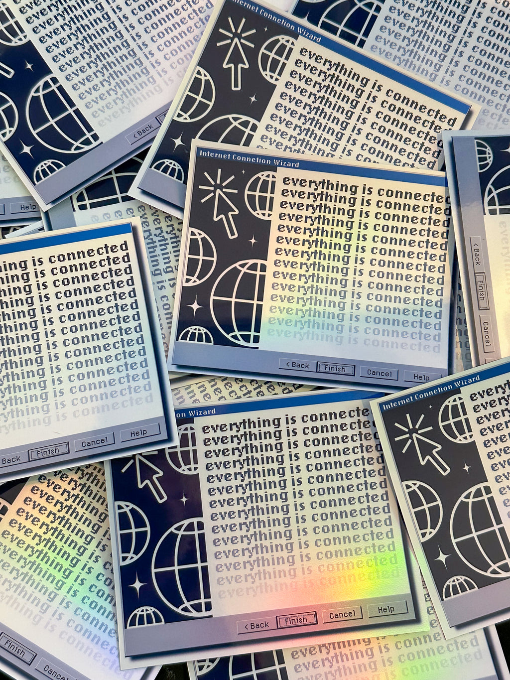 Stack of stickers with 'everything is connected' text and graphics on a colorful background