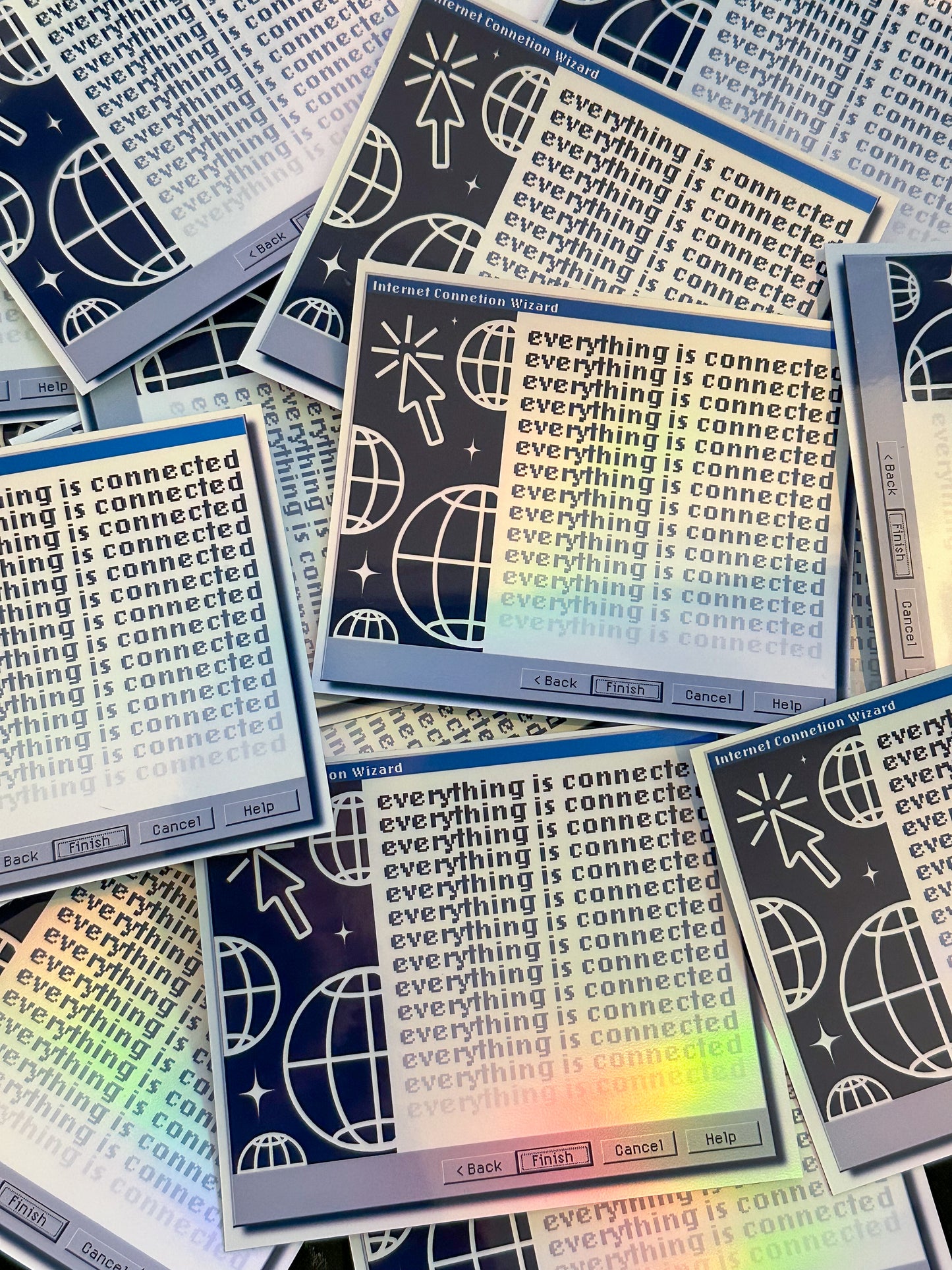 Stack of stickers with 'everything is connected' text and graphics on a colorful background